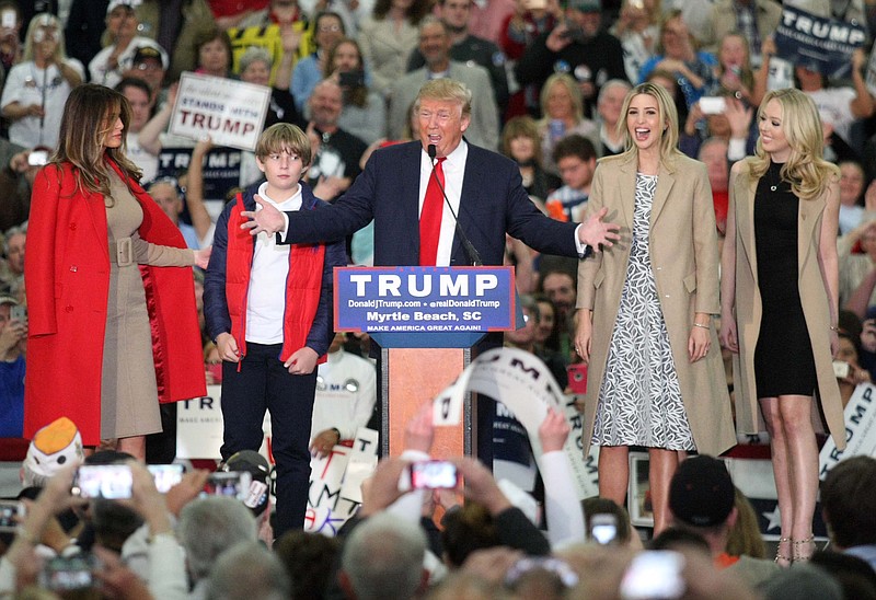 
              Republican presidential candidate Donald Trump, middle, speaks near his wife, Melania, left, son Baron, daughter Ivanka, second from right, and daughter Tiffany during a campaign event at the Myrtle Beach Convention Center on Tuesday, Nov. 24, 2015, in Myrtle Beach, S.C. (AP Photo/Willis Glassgow)
            
