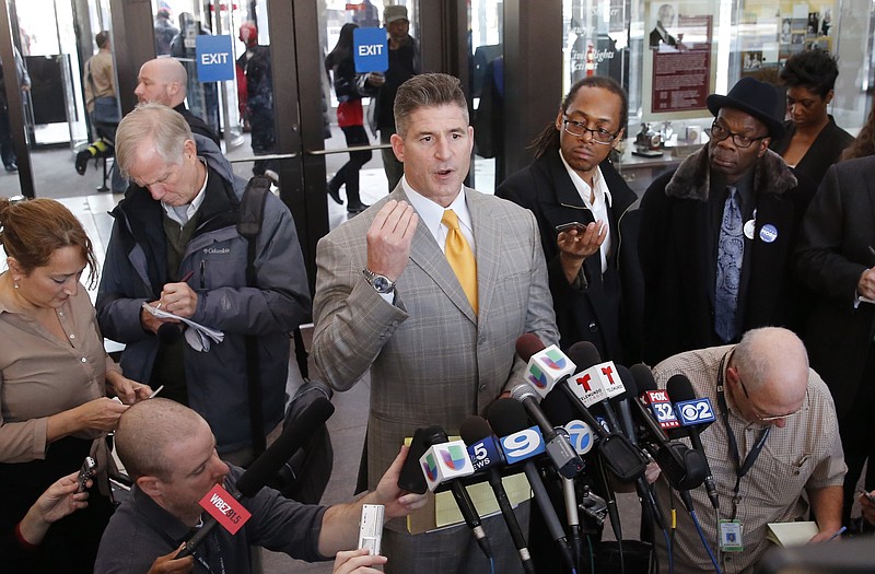 Attorney Daniel Herbert, center, talks to reporters after the bond hearing for his client, Chicago police officer Jason Van Dyke, on murder charges in the killing of 17-year-old Laquan McDonald, Tuesday, Nov. 24, 2015, in Chicago. 