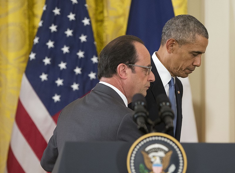 President Barack Obama and French President Francois Hollande walk off stage at the end of their news conference in the East Room of the White House in Washington, Tuesday, Nov. 24, 2015.