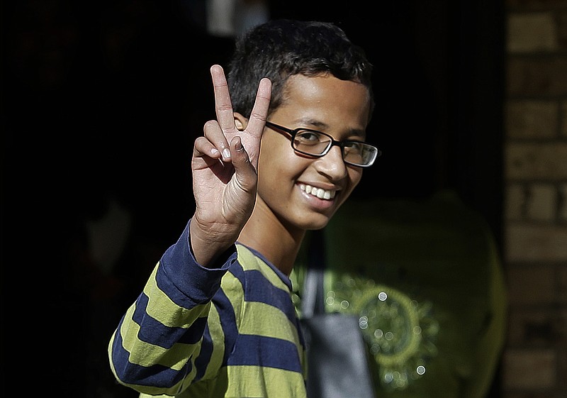 This Sept. 17, 2015, file photo shows Ahmed Mohamed, 14, gestures as he arrives to his family's home in Irving, Texas.