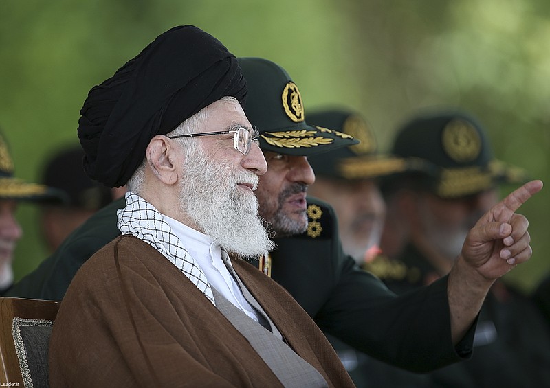 
              FILE -- In this file picture released by the official website of the office of the Iranian supreme leader on Wednesday, May 20, 2015, Supreme Leader Ayatollah Ali Khamenei listens to Revolutionary Guard commander Mohammad Ali Jafari during a graduation ceremony of a group of the guard's officers in Tehran, Iran. In remarks to commanders of the elite Revolutionary Guard Wednesday, Nov. 25, 2015, Khamenei said the United States is using "money and sex" to try to infiltrate the Islamic Republic and warns Iranians not to fall into the "enemy's trap." (Office of the Iranian Supreme Leader via AP, File)
            