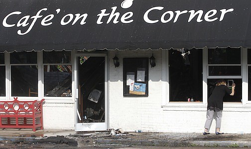 Staff Photo by Dan Henry / The Chattanooga Times Free Press- 5/27/14. Isabel McCall, a friend of the owner, takes photos with her iPad of the damage sustained to Cafe on the Corner after an overnight fire destroyed the restaurant atop Lookout Mountain. 