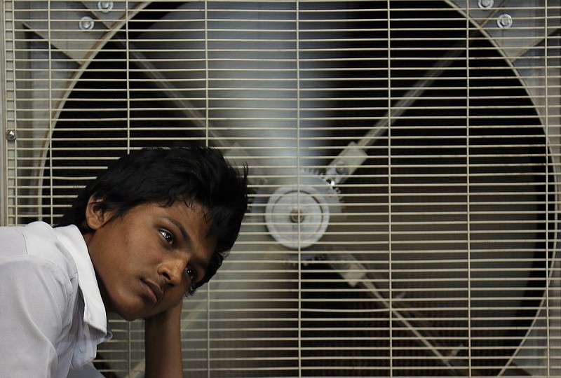 
              FILE - In this May 31, 2015 file photo, an Indian man rests in front of an air cooler to cool himself on a hot summer day in Hyderabad, in the southern Indian state of Telangana. Because of man-made global warming and a strong El Nino, Earth’s wild weather this year is bursting the annual heat record, the World Meteorological Organization announced Wednesday. (AP Photo/Mahesh Kumar A., File)
            