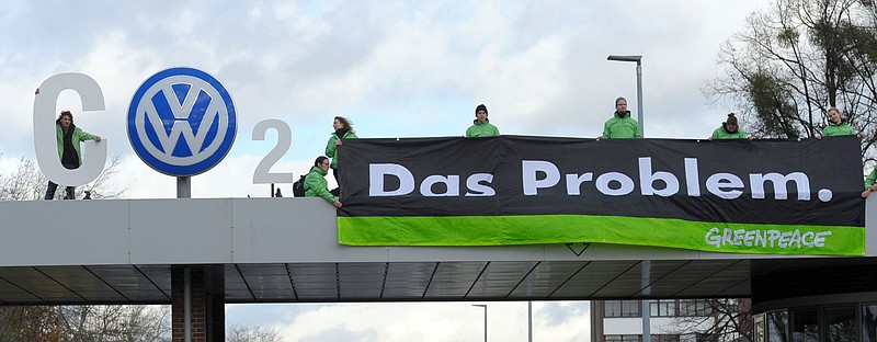 
              FILE - In this Nov. 9, 2015, file photo, Greenpeace activists stand with "CO2" formed with the VW logo and a banner that reads "the problem" above the Volkswagen factory gate in Wolfsburg, Germany. California air quality regulators on Wednesday, Nov. 25, 2015, demanded a recall of up to 16,000 additional Volkswagen, Audi and Porsche diesels as the Volkswagen emissions scandal widened. (Peter Steffen/dpa via AP, File)
            