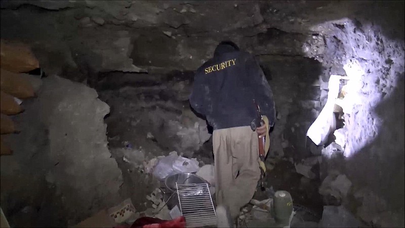 In this image made from video taken on Sunday, Nov. 22, 2015, a member of Kurdish security forces shows a tunnel complex under the city of Sinjar, northern Iraq that were used by Islamic State fighters to move undetected and avoid coalition airstrikes before the town was retaken from the militants.