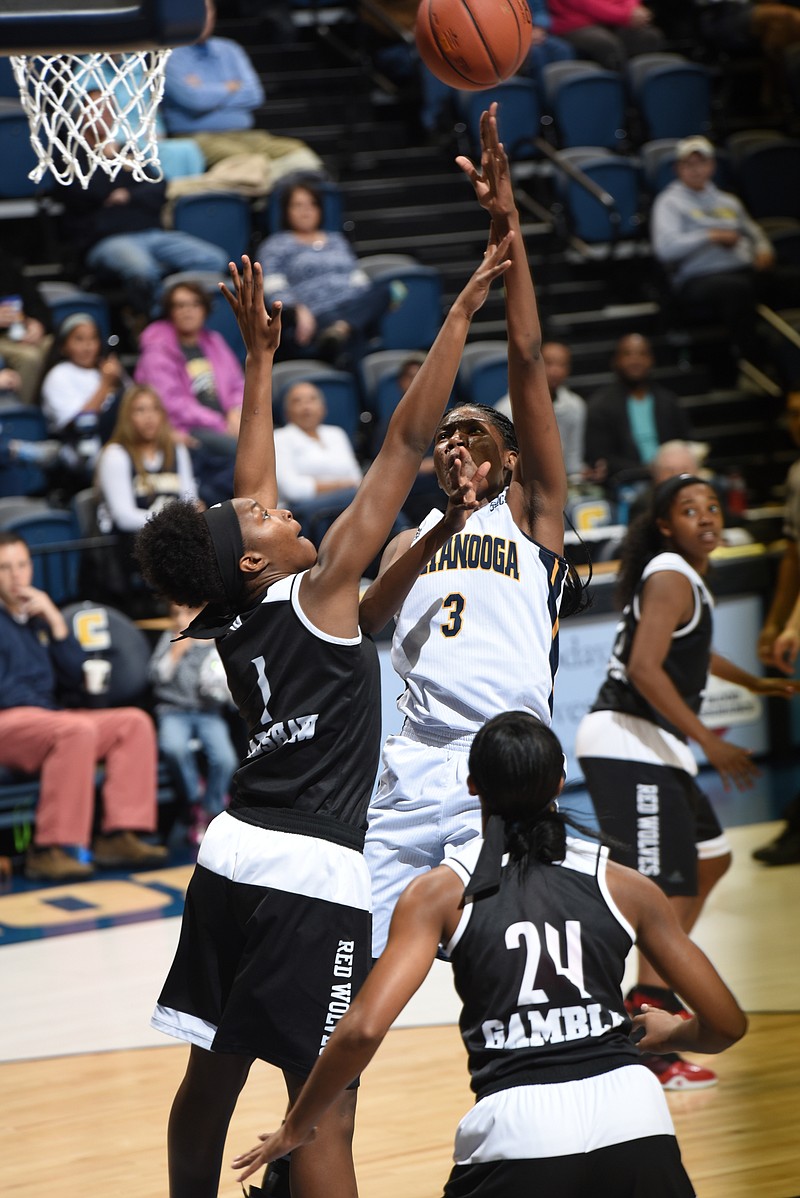 Lady Mocs' Jasmine Joyner (3) puts up one of her first half 2-point buckets over Arkansas State's Lauren Bradshaw (1) Wednesday at McKenzie Arena.