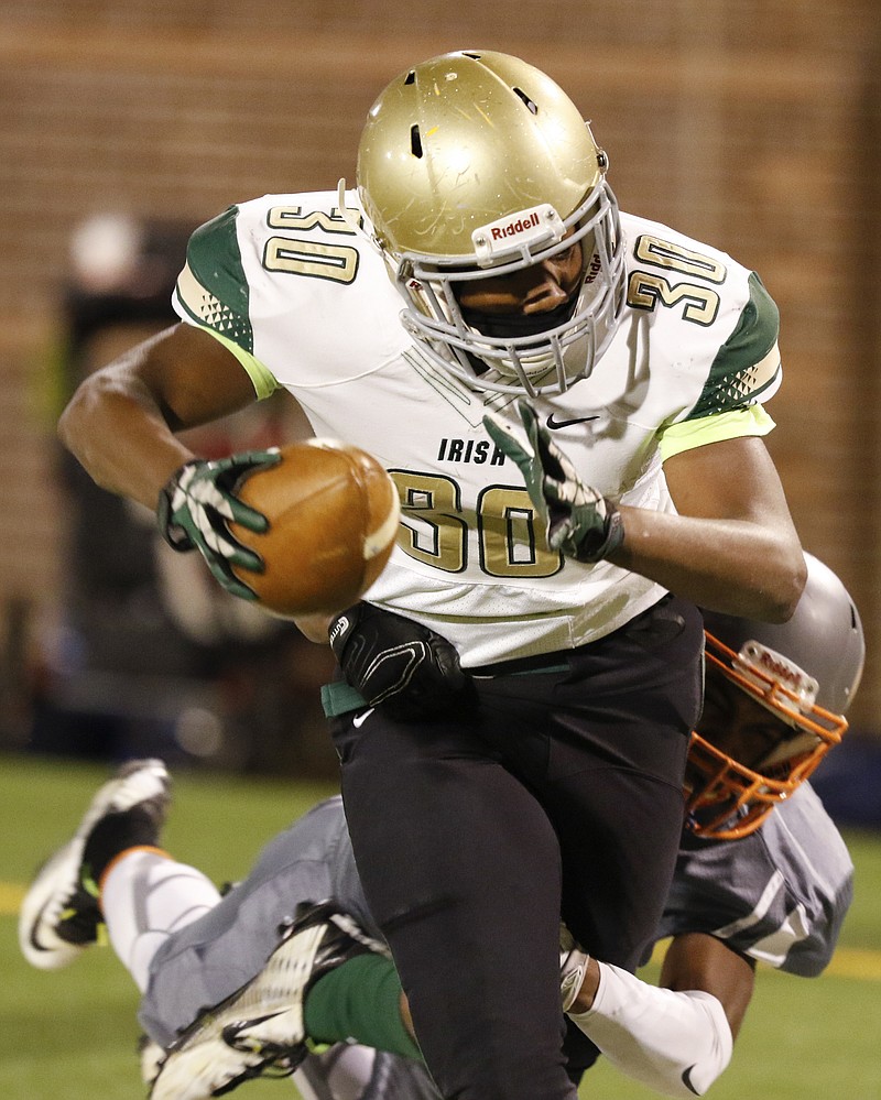 *Staff Photo by Dan Henry / The Chattanooga Times Free Press- 11/20/15. Notre Dame's Akil Sledge (30) attempts to shake East Ridge's BJ Church (20) during Friday's quarterfinal playoff game on November 20, 2015. 