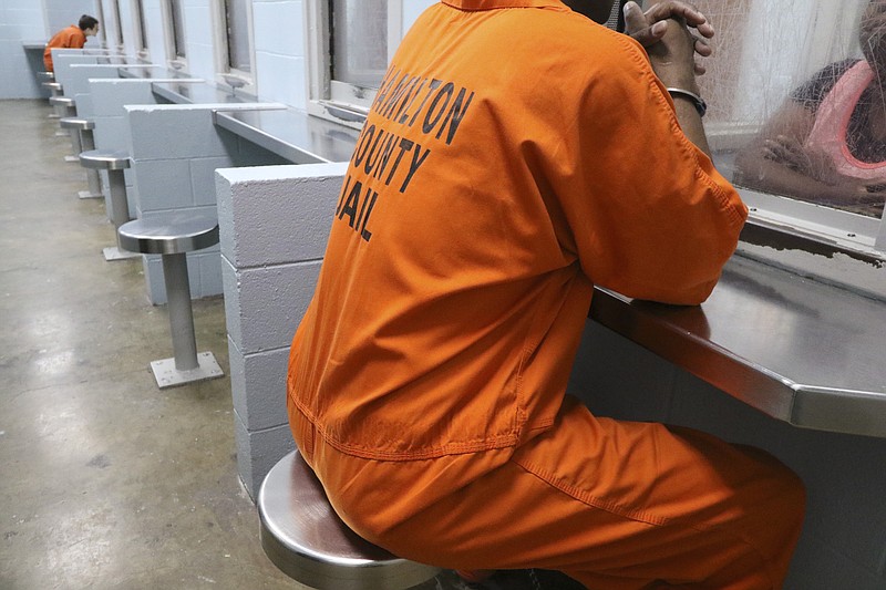 An inmate and his visitor converse during a scheduled visitation at the Hamilton County Jail in downtown Chattanooga on August 5, 2015. There has been an increase of cancellations of inmate visitations that have occurred last minute recently due to limited staffing at the jail. 