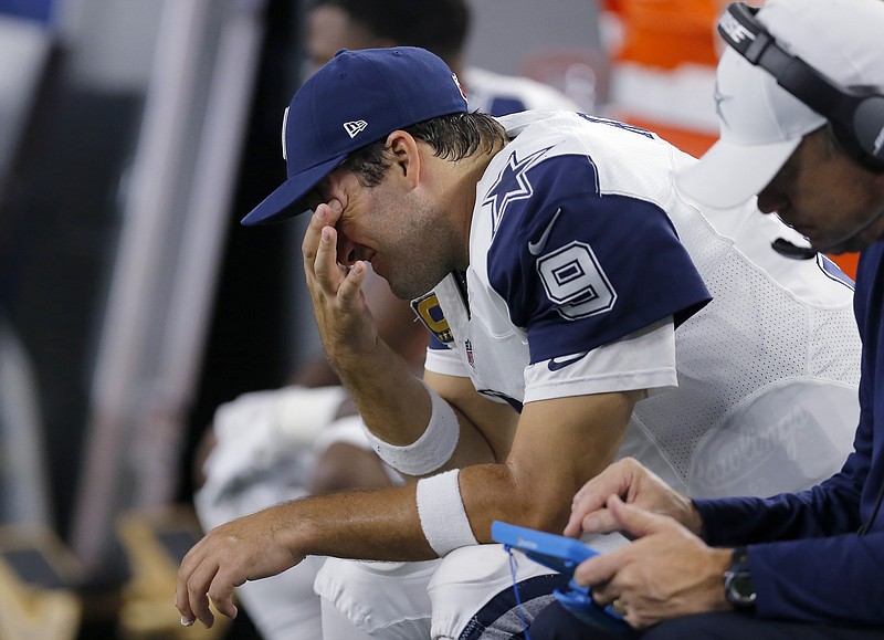 
              Dallas Cowboys quarterback Tony Romo sits on the bench after throwing his third interception of the first half of an NFL football game against the Carolina Panthers, Thursday, Nov. 26, 2015, in Arlington, Texas. (AP Photo/Brandon Wade)
            