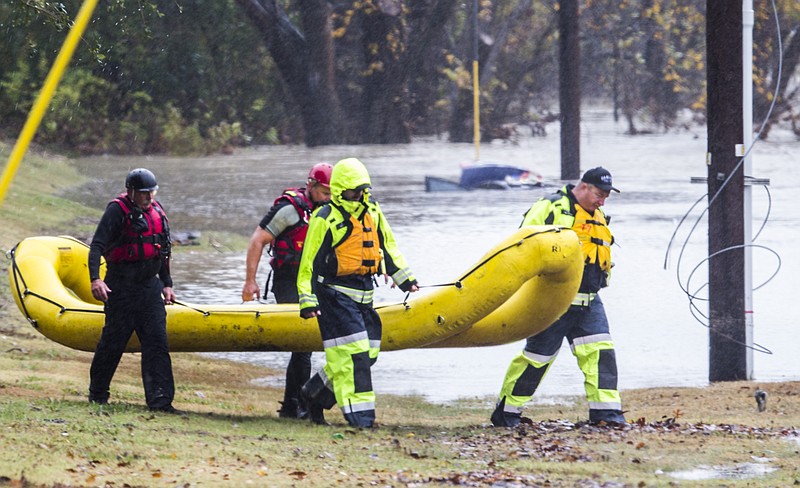 
              Garland Fire Department rescue teams tend to a vehicle submerged in floodwaters Friday, Nov. 27, 2015, in Garland, Texas.  (Ashley Landis /The Dallas Morning News via AP) MANDATORY CREDIT; MAGS OUT; TV OUT; INTERNET USE BY AP MEMBERS ONLY; NO SALES
            