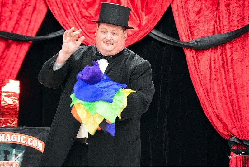 Michael Frisbee, president of the Chattanooga Magic Club, performs at the organization's recent fundraiser at Chester Frost Park.