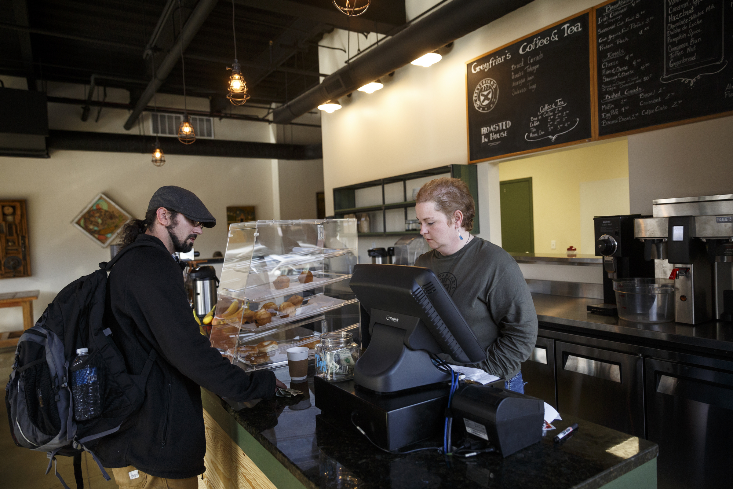 Manager Rebecca Bryson-Spencer, right, serves Jeff Merritt at Greyfriar's Coffee & Tea Co. on Friday, Nov. 27, 2015, in Chattanooga, Tenn. The Chattanooga coffee house moved from its location on Broad Street to Market Street adjacent to the Sports Barn.