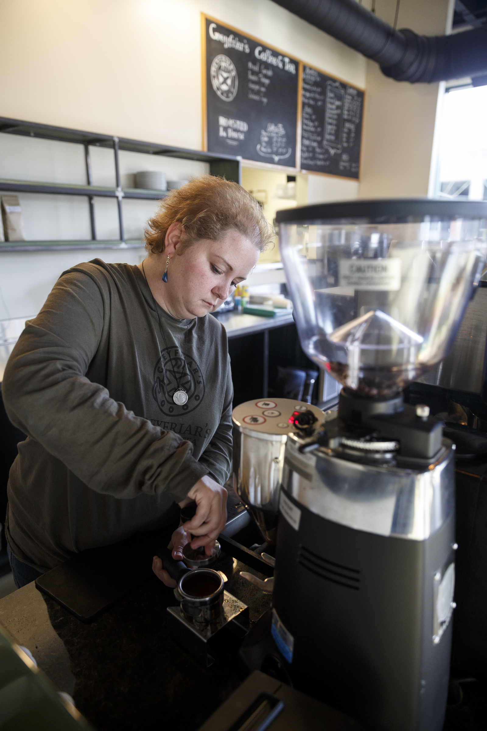 Manager Rebecca Bryson-Spencer makes a latte at Greyfriar's Coffee & Tea Co. on Friday, Nov. 27, 2015, in Chattanooga, Tenn. The Chattanooga coffee house moved from its location on Broad Street to Market Street adjacent to the Sports Barn.