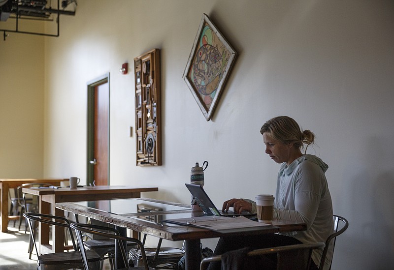 Sofia Bunger works on her laptop at Greyfriar's Coffee & Tea Co. on Friday, Nov. 27, 2015, in Chattanooga, Tenn. 