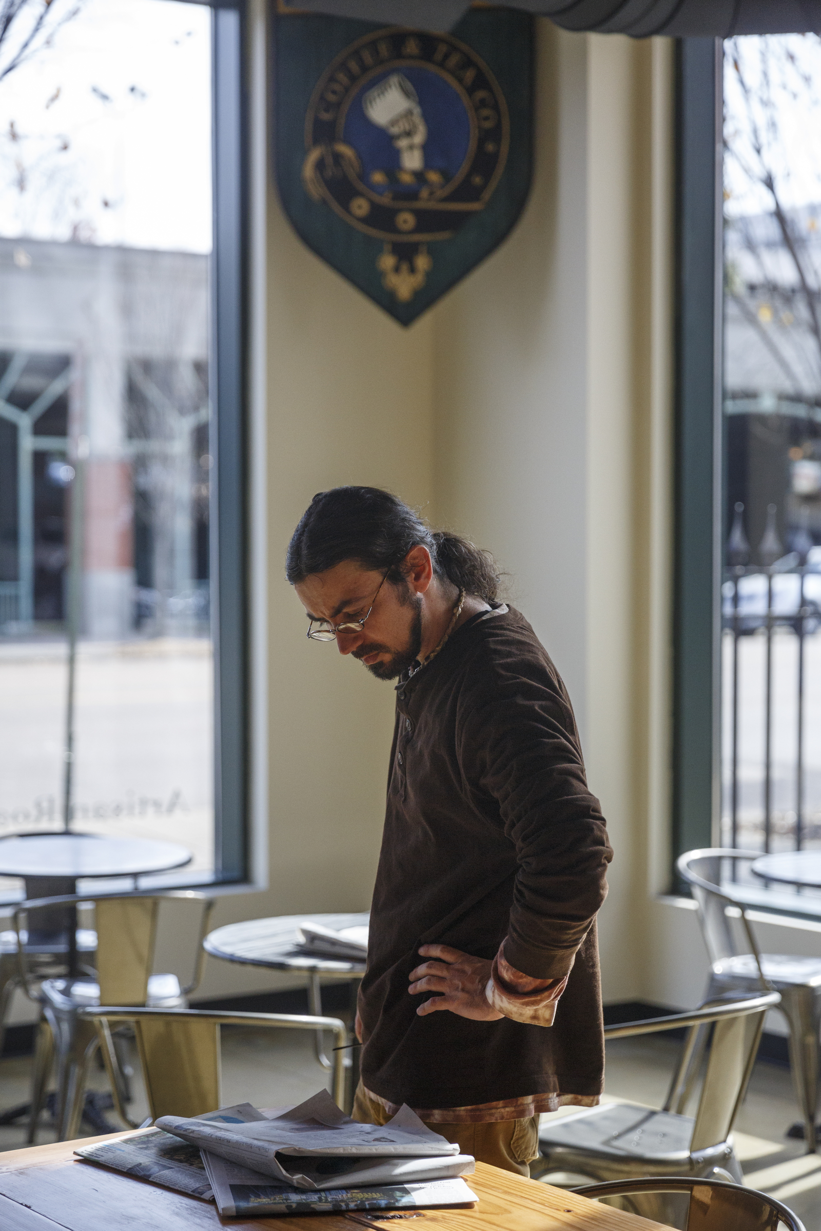 Jeff Merritt looks at the newspaper at Greyfriar's Coffee & Tea Co. on Friday, Nov. 27, 2015, in Chattanooga, Tenn. The Chattanooga coffee house moved from its location on Broad Street to Market Street adjacent to the Sports Barn.