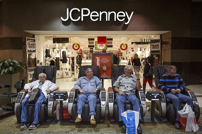 Gordon McKamey, Gene Ware, Sanford Elrod, and Carlton Lively, from left, wait in massage recliners for their wives outside of JC Penney during Black Friday shopping at Hamilton Place Mall on Friday, Nov. 27, 2015, in Chattanooga, Tenn.