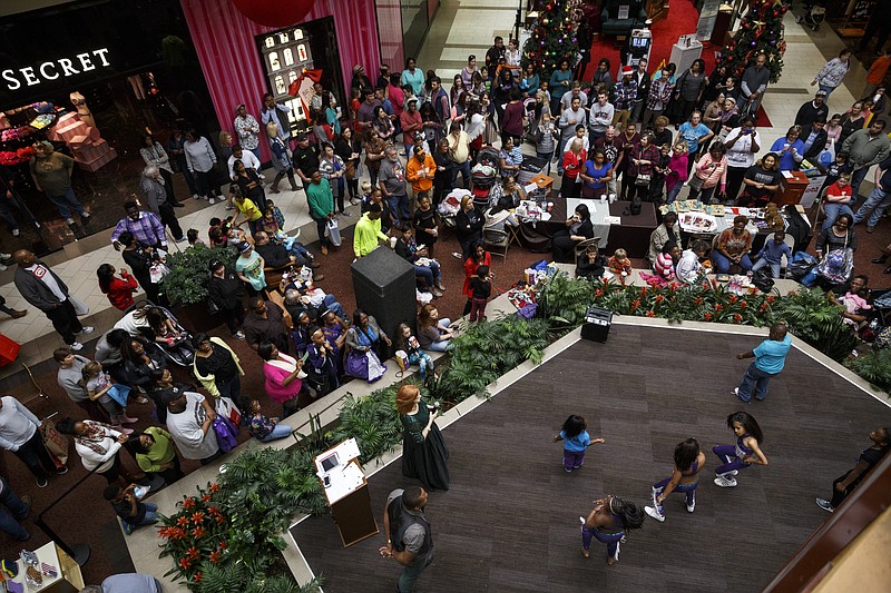 A crowd gathers to watch a Toys for Tots donation drive during Black Friday shopping at Hamilton Place mall on Friday, Nov. 27, 2015, in Chattanooga, Tenn.