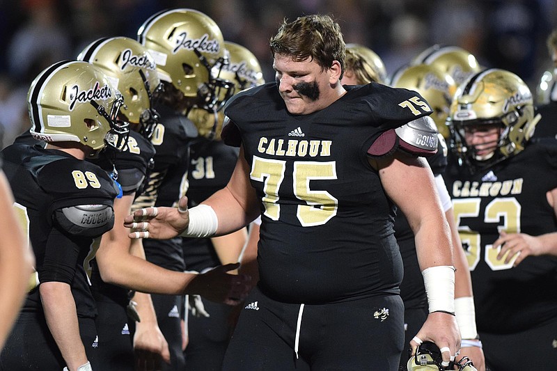 Calhoun senior lineman Austin Stout (75) encourges his fellow Yellow Jackets.  The Elbert County Blue Devils visited the Calhoun Yellow Jackets in a GHSA Football Playoff game on Friday November 27, 2015.