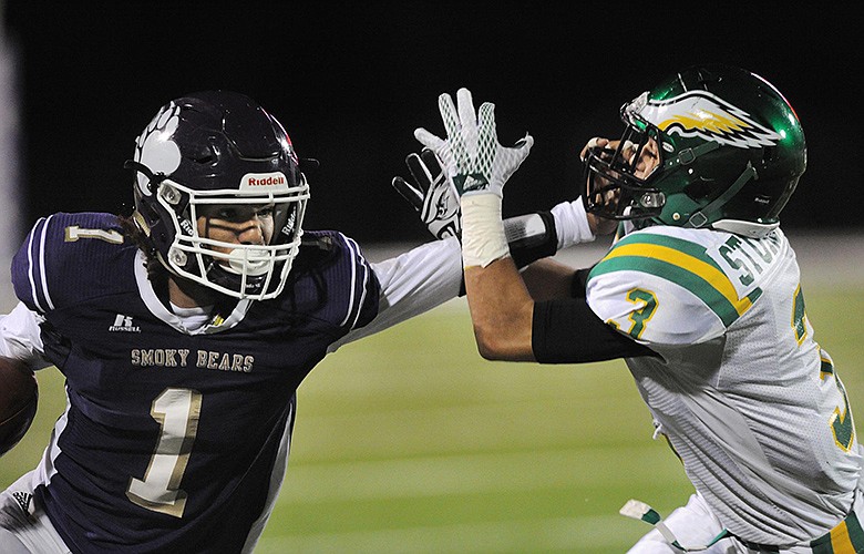 Sevier County's Devante Matthews, left, stiff-arms Rhea County's Chris Sturgeon during Friday's Class 5A state semifinal game.