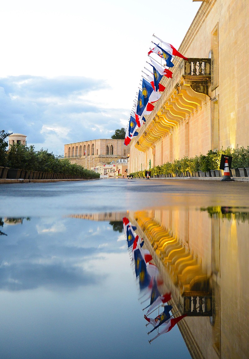 
              Flags wave on a balcony of the Mediterranean Conference Centre where the CHOGM (Commonwealth heads of Government meeting) is scheduled to open in Valletta, Malta, Friday, Nov. 27, 2015. (AP Photo/Rene Rossignaud)
            