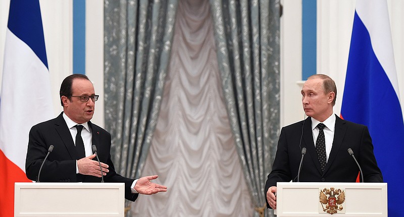 
              Russian President Vladimir Putin, right, and France's President Francois Hollande, give a joint press conference after their meeting in Moscow, Russia, Thursday, Nov. 26, 2015. French President Francois Hollande is in Moscow on Thursday to push for a stronger coalition against Islamic State militants in Syria, trying to unite France, the U.S. and Russia. (Stephane de Sakutin/Pool Photo via AP)
            