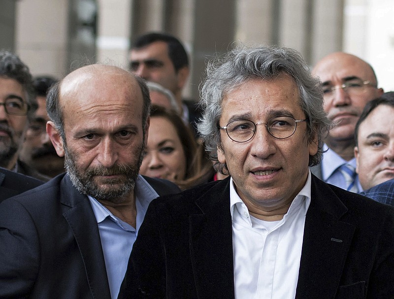 
              In this Thursday, Nov. 26, 2015 photo, Can Dundar, right, the editor-in-chief of opposition newspaper Cumhuriyet, and Erdem Gul, left, the paper's Ankara representative, speak to the media outside a courthouse in Istanbul, Turkey. In new blow to media freedoms in Turkey, a court on Thursday ordered the two prominent opposition journalists jailed pending trial over charges of willingly aiding an armed group and of espionage for revealing state secrets for their reports on alleged arms smuggling to Syria. In May, the Cumhuriyet paper published what it said were images of Turkish trucks carrying ammunition to Syrian militants. (Vedat Arik/Cumhuriyet via AP) TURKEY OUT
            