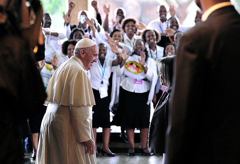 People cheer Pope Francis as he meets with Director-General of the United Nations Office at Nairobi (UNON) Sahle-Work Zewde, right, upon his arrival at the United Nations regional office, in Nairobi, Kenya, Thursday, Nov. 26, 2015 (Simon Maina/Pool Photo via AP).