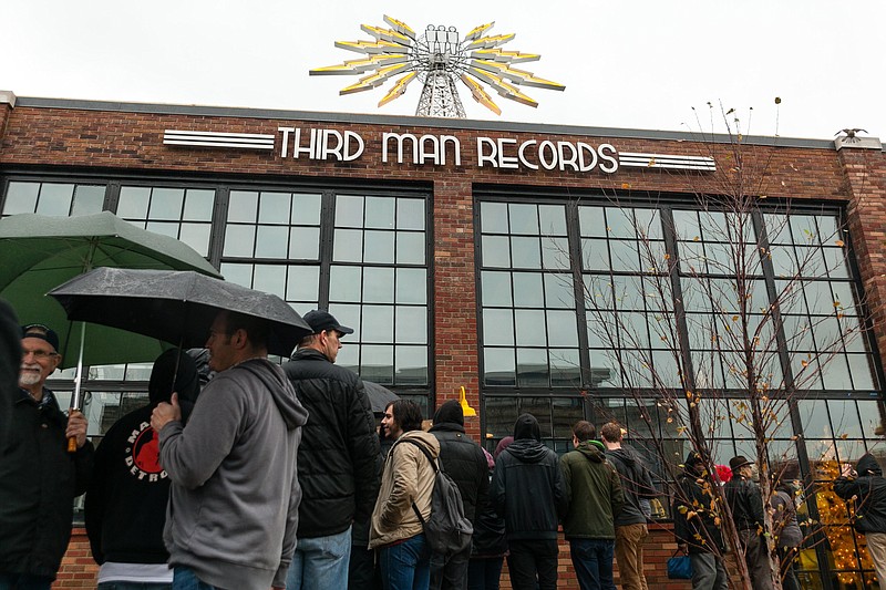 
              Hundreds of fans waited in the rain for their chance to attend the grand opening festivities at Third Man Records in Detroit on Friday, Nov. 27, 2015. (John Froelich/Detroit Free Press via AP)
            