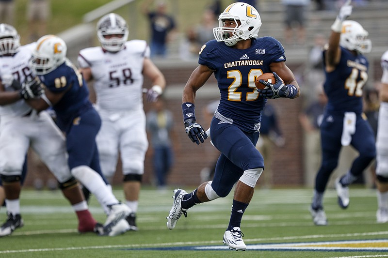 Staff photo by Doug Strickland / UTC defensive back Lucas Webb (29) breaks away for a touchdown after intercepting the ball in the first half of the Mocs' FCS playoff football game against Fordham at Finley Stadium on Saturday, Nov. 28, 2015, in Chattanooga, Tenn.