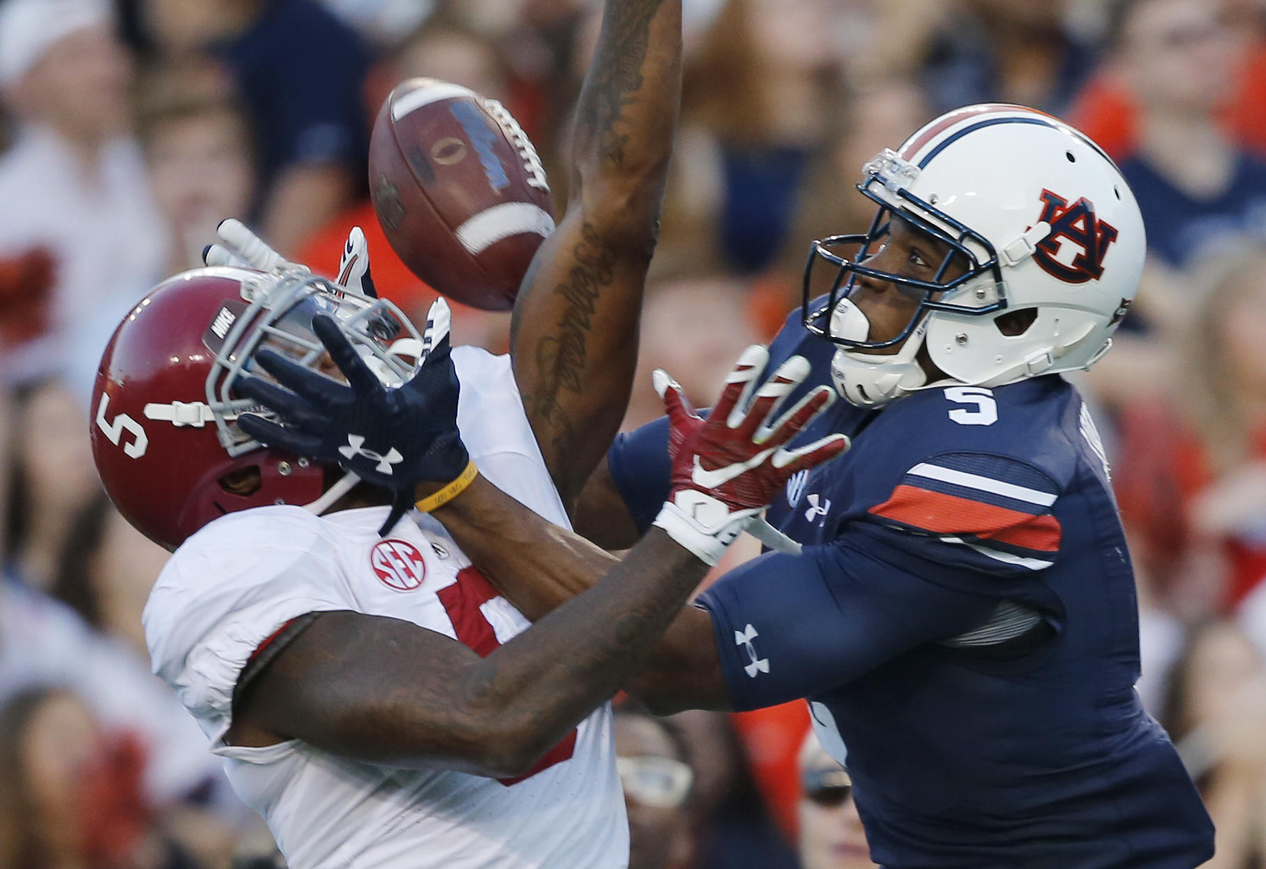 Auburn wide receiver Ricardo Louis (5) misses the ball against Alabama defensive back Cyrus Jones (5) in the first half during an NCAA college football game, Saturday, Nov. 28, 2015, in Auburn, Ala. (AP Photo/Gerald Herbert)
