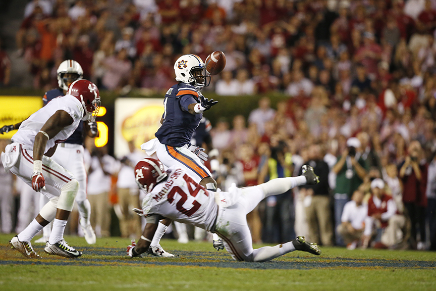 Auburn wide receiver Jason Smith (4) tips a pass to himself before scoring a touchdown during the second half of an NCAA college football game against Alabama, Saturday, Nov. 28, 2015, in Auburn, Ala. (AP Photo/Gerald Herbert)