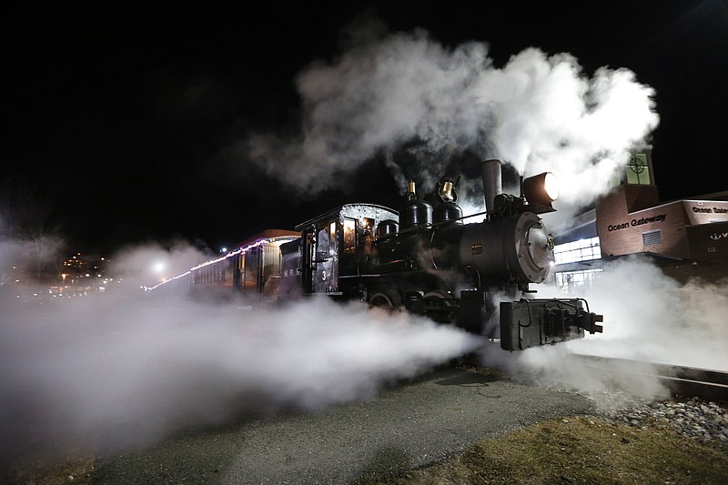 
              Steams shoots out from a 1913 steam locomotive as the Polar Express begins it's journey to the "North Pole" on the Maine Narrow Gauge Railroad, Friday, Nov. 27, 2015, in Portland, Maine. The popular train ride, based on the well-known children's book, has rides scheduled throughout the holiday season. Passengers ride about a mile and a half along Casco Bay on the Eastern Promenade to the “North Pole.” (AP Photo/Robert F. Bukaty)
            