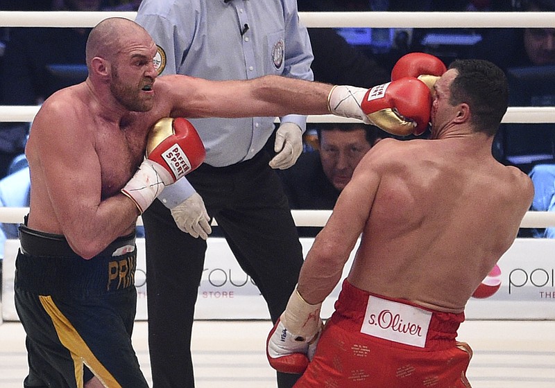 
              Britain's Tyson Fury, left, punches Ukraine's Wladimir Klitschko and in a world heavyweight title fight for Klitschko's WBA, IBF, WBO and  IBO belts in the Esprit Arena in Duesseldorf, western Germany, Saturday, Nov. 28, 2015. (AP Photo/Sebastian Konopka)
            