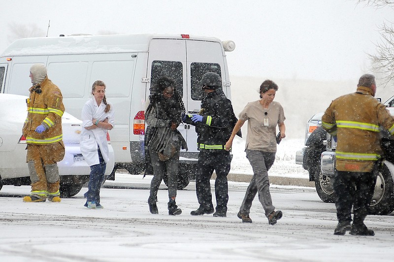 
              People are escorted away after a deadly shooting at a Planned Parenthood clinic Friday, Nov. 27, 2015, in Colorado Springs, Colo. A gunman opened fire at the clinic on Friday, authorities said, wounding multiple people. (Daniel Owen/The Gazette via AP) MAGS OUT; MANDATORY CREDIT
            