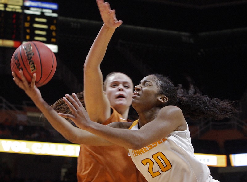 Tennessee guard Te'a Cooper is fouled by Texas center Kelsey Lang while shooting during Sunday's game in Knoxville. The Lady Vols' home winning streak ended at 27 games with their 64-53 loss to the Longhorns.