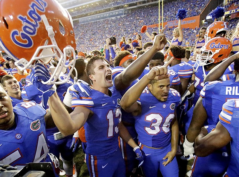 University of Florida players, including linebacker Daniel McMillian (13) and wide receiver Roger Dixon (36), celebrate after the Gators beat Tennessee 28-27 in September in Gainesville, Fla.