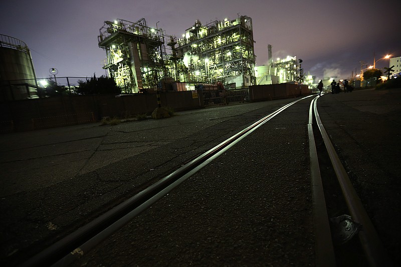 
              In this Nov. 29, 2014 photo, a factory near the tracks of freight trains is seen at night in Kawasaki, south of Tokyo. Japanese industrial output rose 1.4 percent in October, 2015,  from the month before, below forecasts and a decrease from the year before. Government data released Monday, Nov. 30, 2015,  also showed retail spending fell in October from a year earlier. (AP Photo/Eugene Hoshiko)
            