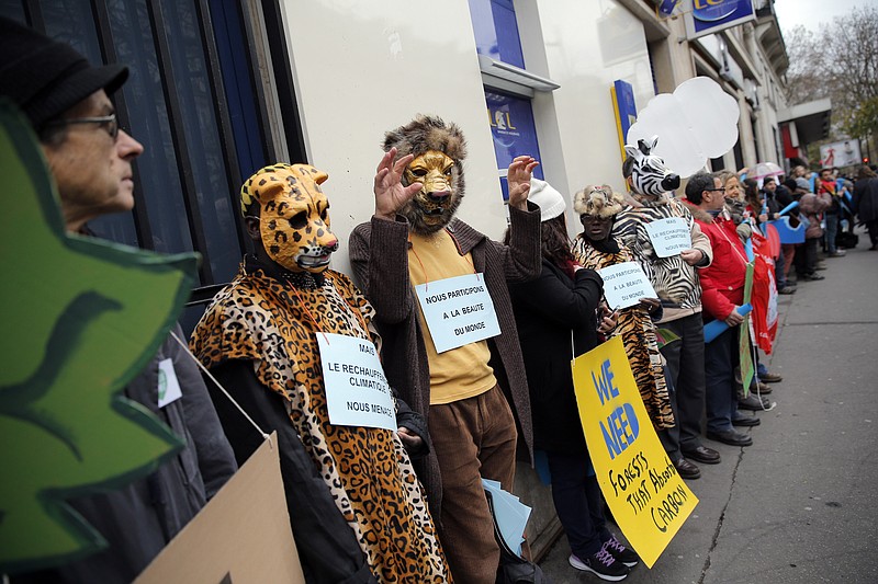 Activists form a human chain during a protest ahead of the 2015 Paris Climate Conference, in Paris, Sunday, Nov. 29, 2015. More than 140 world leaders are gathering around Paris for high-stakes climate talks that start Monday, and activists are holding marches and protests around the world to urge them to reach a strong agreement to slow global warming (AP Photo/Christophe Ena).