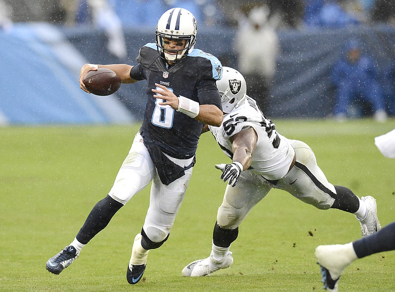 Tennessee Titans quarterback Marcus Mariota (8) scrambles away from Oakland Raiders defensive end Khalil Mack (52) in the second half of an NFL football game Sunday, Nov. 29, 2015, in Nashville, Tenn. (AP Photo/Mark Zaleski)