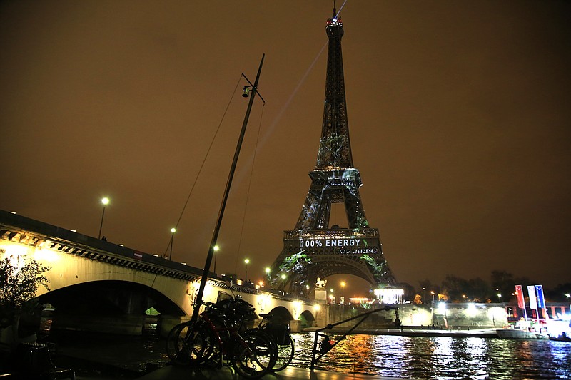 The Eiffel Tower goes green for two weeks of climate talks aimed at a long-term global agreement for all countries to reduce man-made emissions that heat the planet.