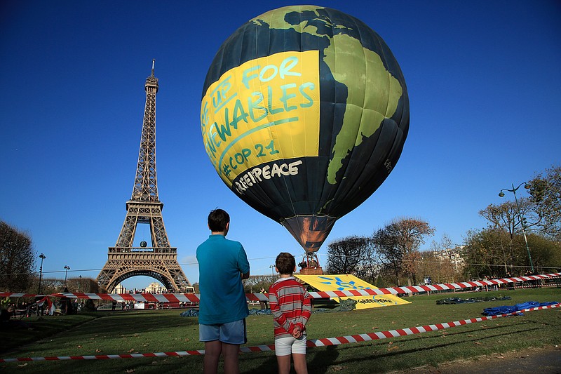 A hot air balloon near the Eiffel Tower appropriately represents the environmental group Greenpeace ahead of the 2015 Paris climate conference, which officially began Monday.