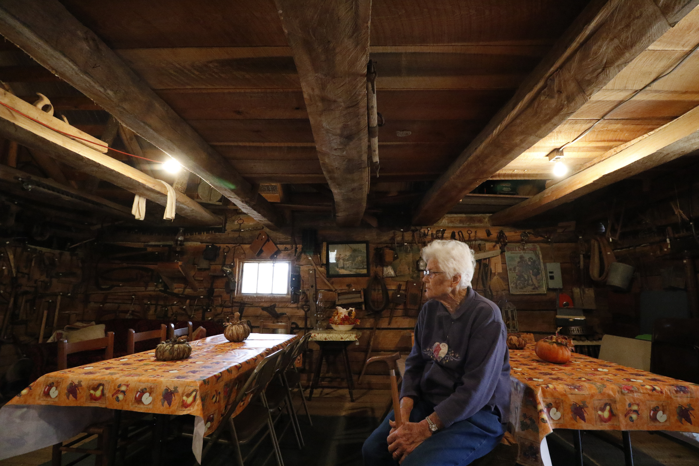Staff Photo by Dan Henry / The Chattanooga Times Free Press- 11/25/15. Nadean Kell, speaks about her late husband Thaxton Kell, who built the log cabin she sits in as well as a number of miniature replicas of structures that were present in the Sequatchie Valley and surrounding areas when he was younger.
