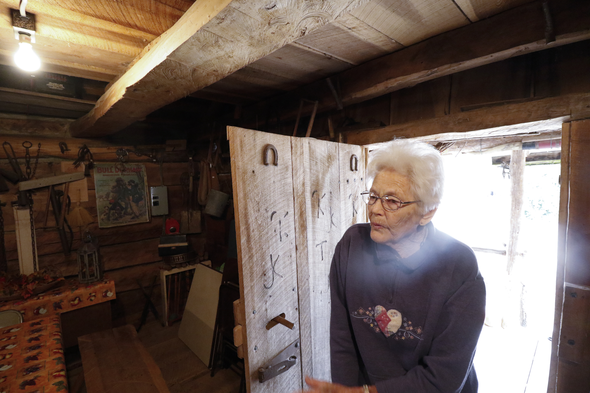 Staff Photo by Dan Henry / The Chattanooga Times Free Press- 11/25/15. Nadean Kell, speaks about her late husband Thaxton Kell, who built the log cabin she enters as well as a number of miniature replicas of structures that were present in the Sequatchie Valley and surrounding areas when he was younger.