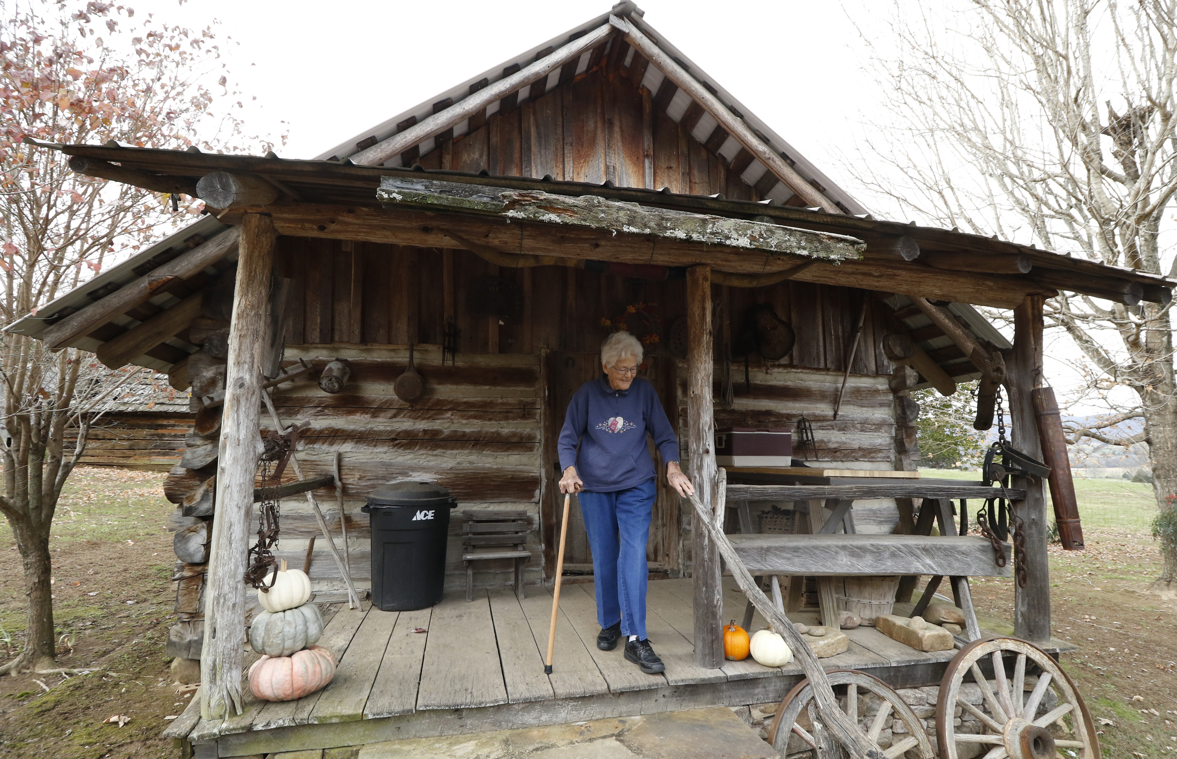 Staff Photo by Dan Henry / The Chattanooga Times Free Press- 11/25/15. Nadean Kell, speaks about her late husband Thaxton Kell, who built the log cabin she stands at as well as a number of miniature replicas of structures that were present in the Sequatchie Valley and surrounding areas when he was younger.