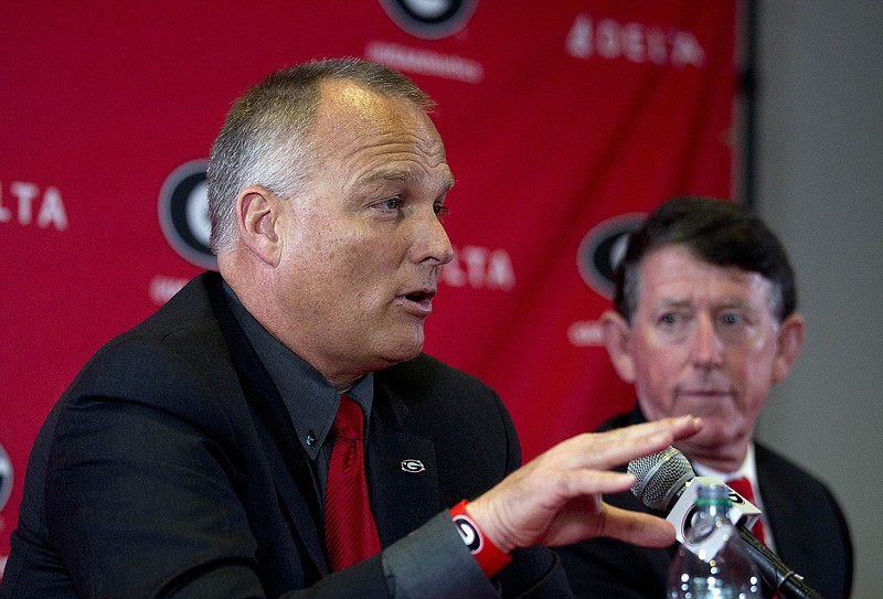 Georgia football coach Mark Richt, who will not be retained after the bowl game, speaks during a news conference Monday as athletic director Greg McGarity looks on.