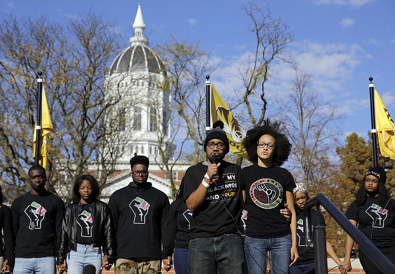 
              FILE - In this Monday, Nov. 9, 2015 file photo, Jonathan Butler, front left, addresses a crowd following the announcement that University of Missouri System President Tim Wolfe would resign, at the university in Columbia, Mo. Officials were slow to handle racial incidents at the University of Missouri, and that contributed to protests, a student hunger strike, a threatened boycott by the football team and ultimately, the resignations of two administrators.    (AP Photo/Jeff Roberson, File)
            