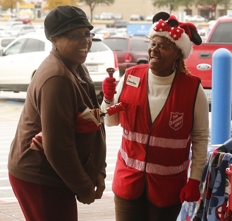 
              In a Nov. 27, 2015 photo, Mansfield resident Vera Green, left, and Salvation Army bellringer Bernice Mitchner, a.k.a Queen Bee, share a laugh outside the Walmart in Mansfield, Texas. The Queen Bee greets everybody with a smile and a wave and some regular shoppers with a hug.  (Ron Baselice/The Dallas Morning News via AP)
            