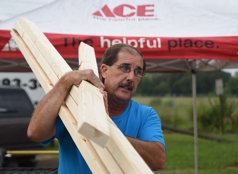 Elder's Ace Hardware employee Tim Dennison carries boards during the United Way of Greater Chattanooga's Day of Caring in September at the Teacher Supply Depot on Roanoke Avenue.