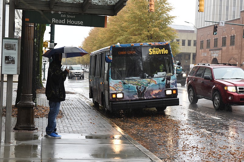 A CARTA Shuttle bus drops off passengers in the 800 block of Broad Street, also in one the bike lanes on Broad Street on Monday, Nov. 30, 2015, in Chattanooga, Tenn. After a grace period, the Chattanooga Parking Authority will begin ticketing businesses and vehicles that violate the new downtown bike lane policy. 