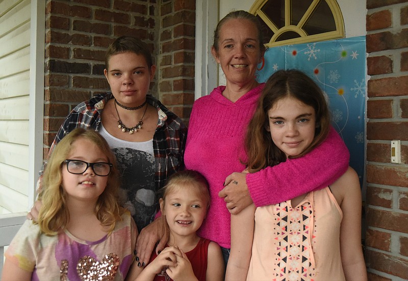 Heather Starr Hanegan stands with her daughters, Krysta, Alayna, Tylin and Gracelyn, clockwise from right, on Tuesday at their Harrison home.
